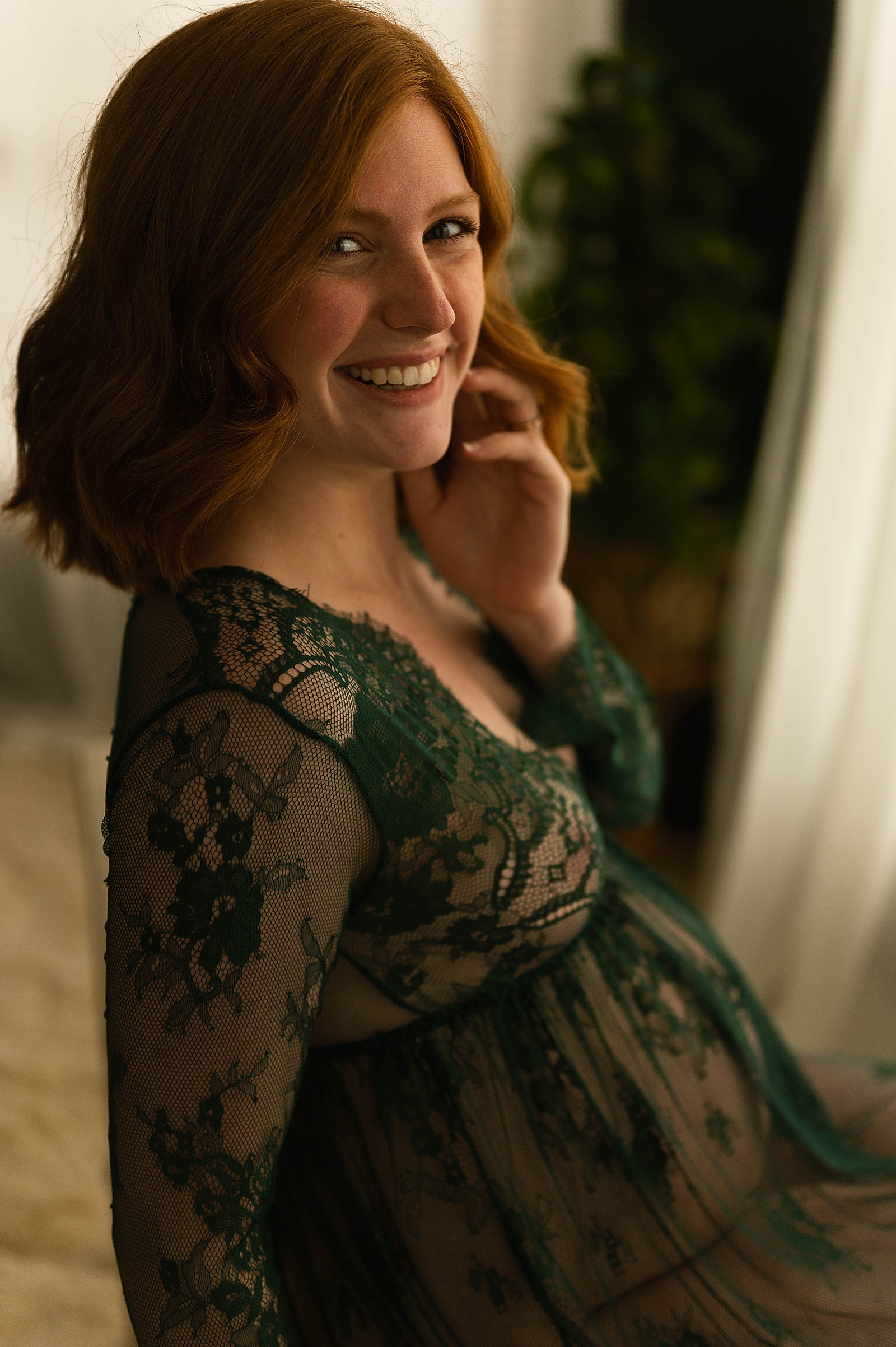 Woman in green lace lingerie at Virginia boudoir studio 