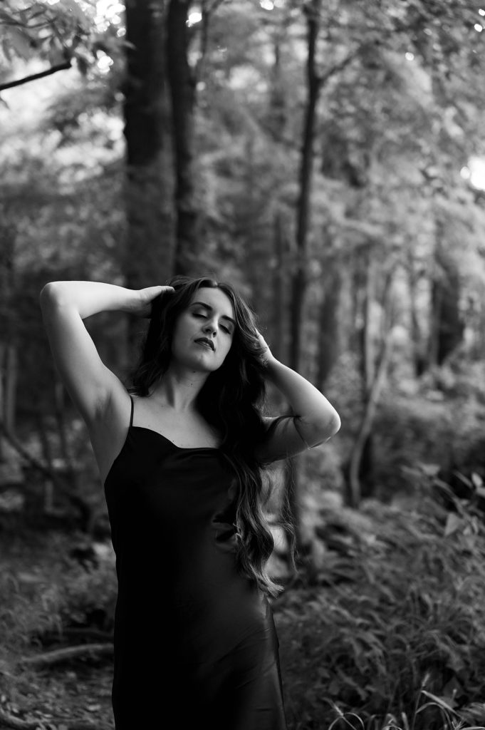 Woman in slip standing in the forest by Richmond boudoir photographer Tease by Hannah Louise