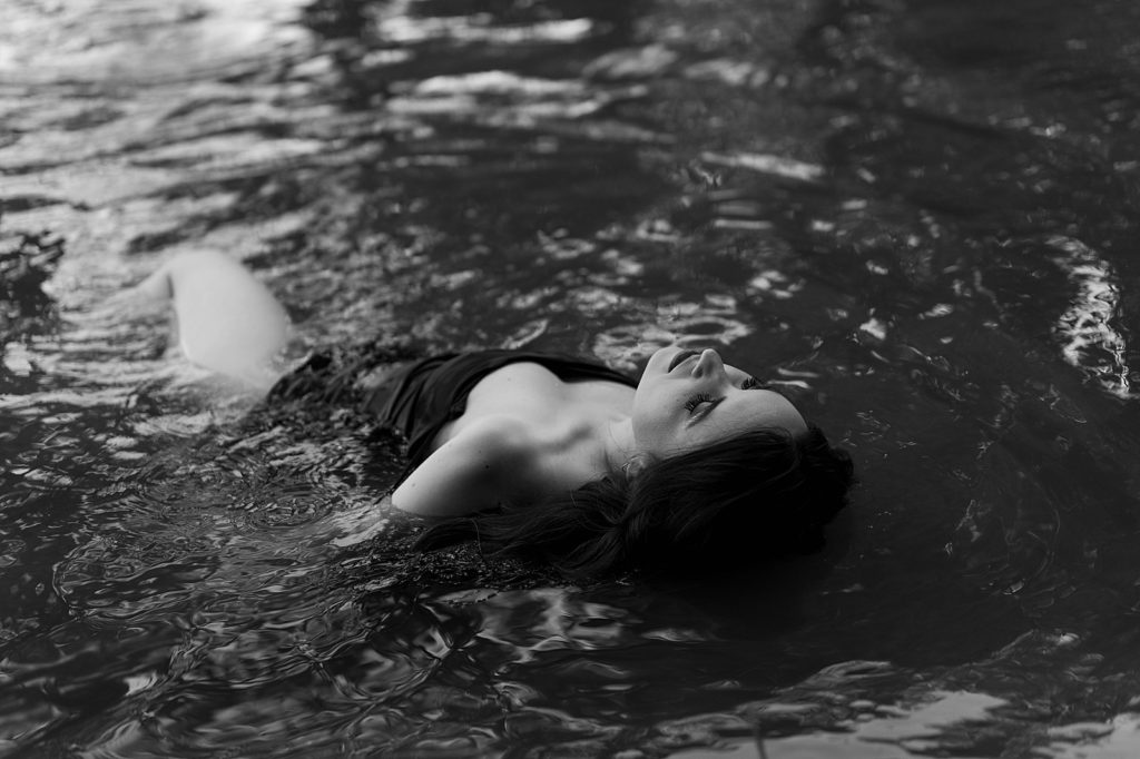 Woman in the water at nature session with Richmond boudoir photographer tease by Hannah louise