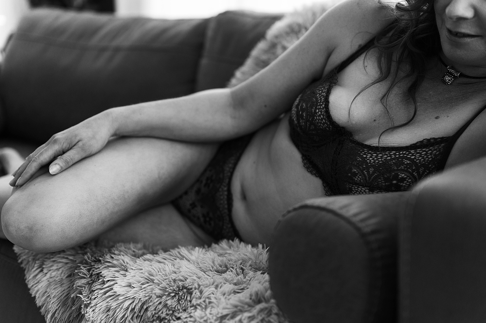 Woman in bra and underwear lying on a couch at Richmond studio by Tease by Hannah Louise