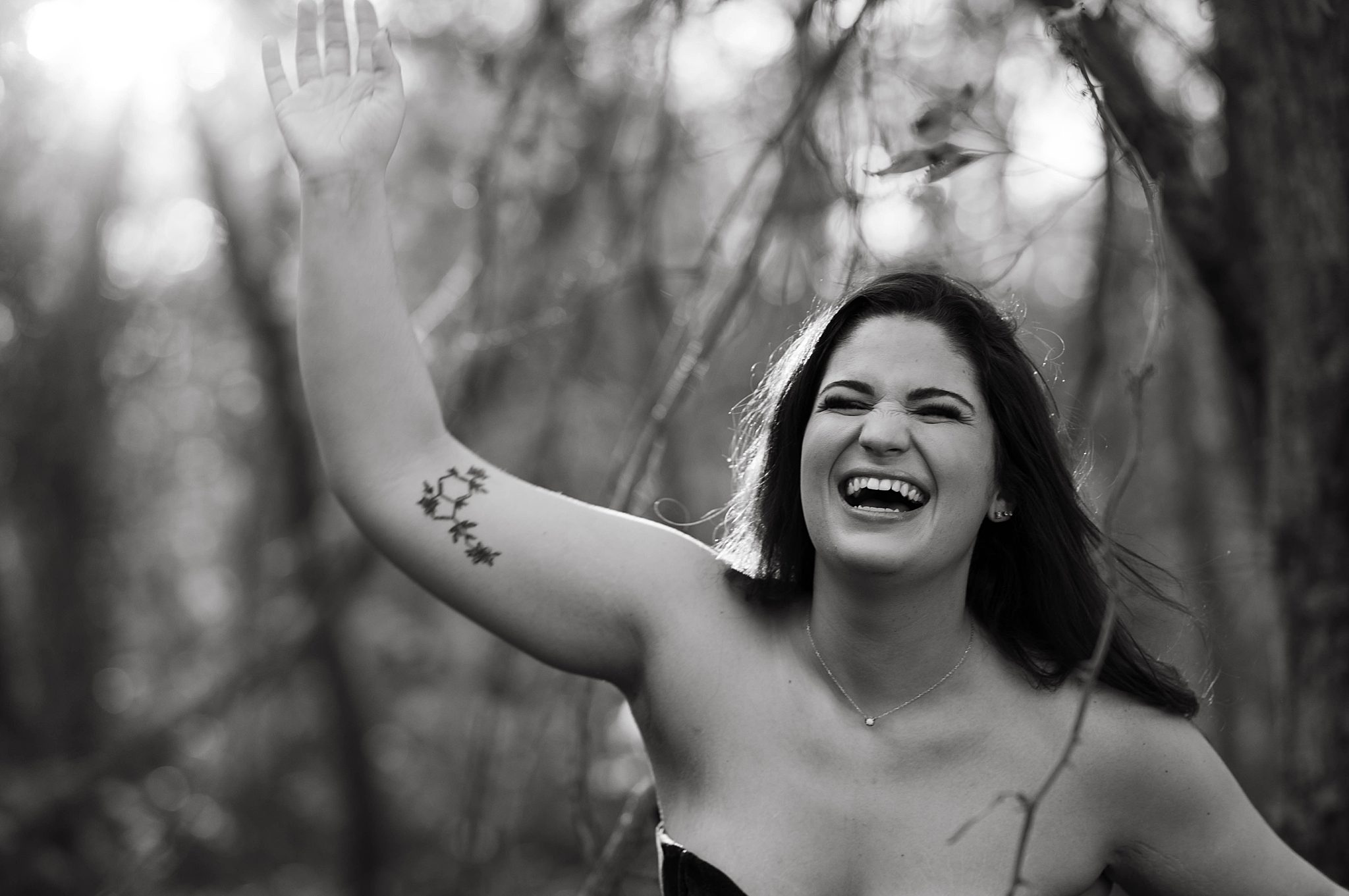 woman smiles with hand in air during icy river session