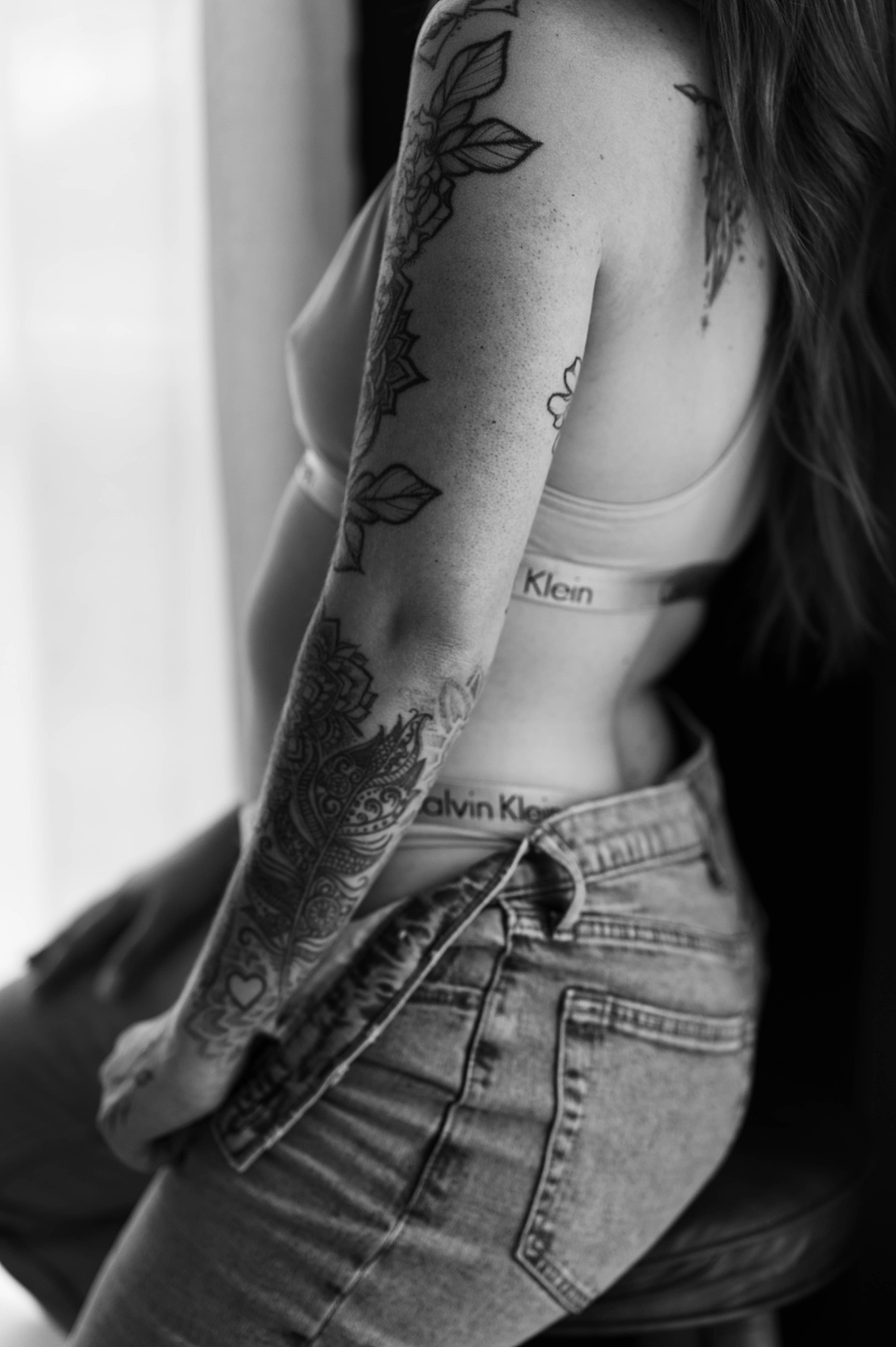 tattooed arm tugs at jeans for Tease by Hannah Louise